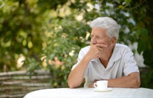 man contemplating all on four denture implant procedure