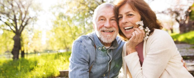 older couple smiling and enjoying the outdoors together