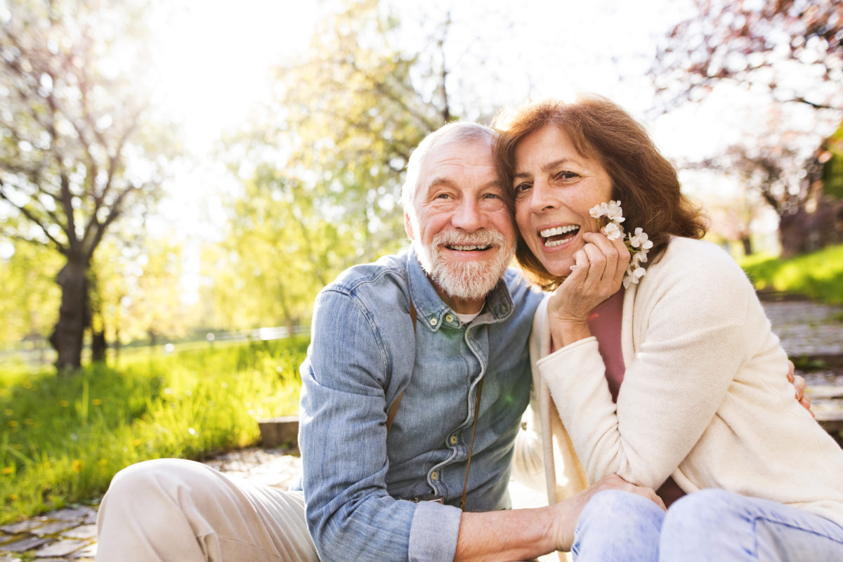older couple smiling and enjoying the outdoors together