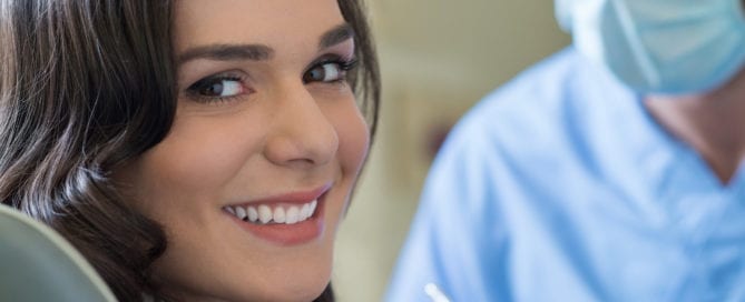 young woman smiling at oral surgery practice