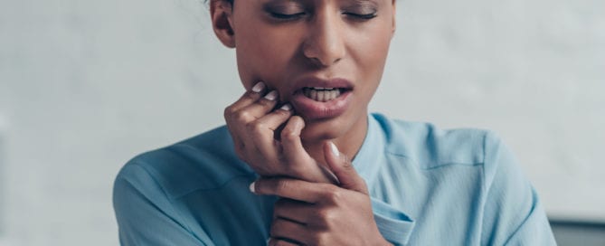 black woman suffering from tmj