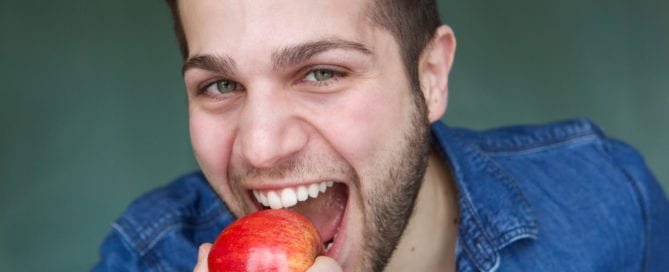 man eating apple