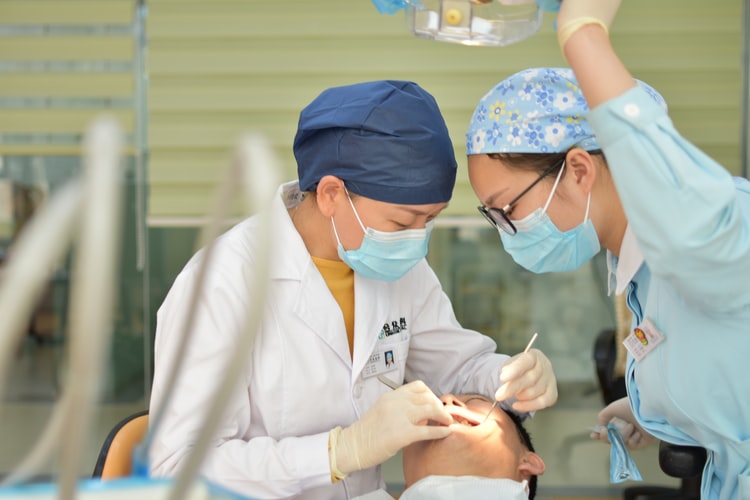 Two Oral surgeons Performing a Dental Procedure