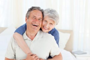 senior couple smiling with all-on-4 dental implants