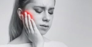 woman suffering from tooth pain