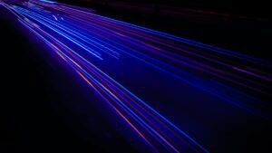 blue and purple laser beams on black background