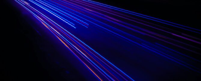 blue and purple laser beams on black background