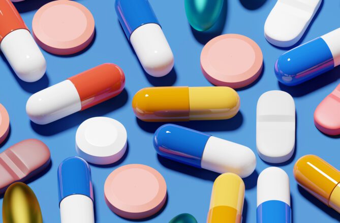 different types of pills on blue background